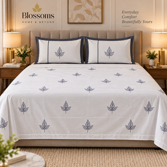 Blossoms embroidered designer bedsheet with 2 pillows .